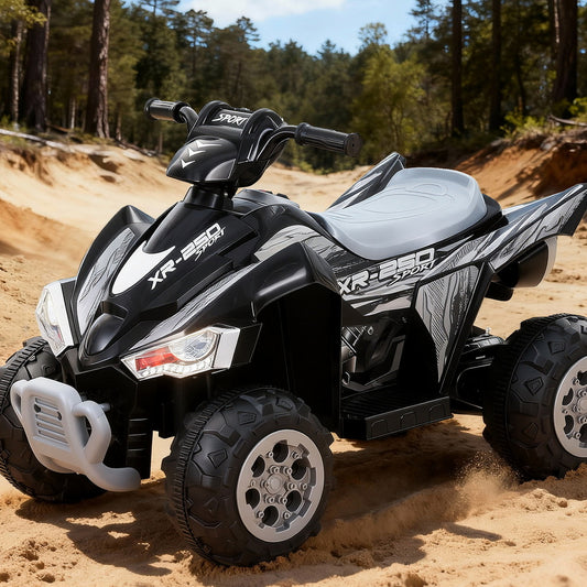 Black and gray ATV on a sandy terrain with trees in the background