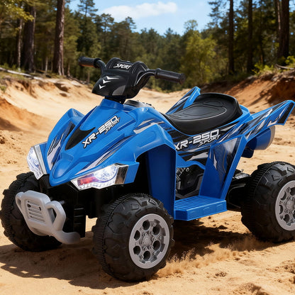 Blue toy ATV on a sandy surface with trees in the background