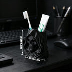 3D-printed hooded skull organizer, perfect for storing toothbrushes and toothpaste in your bathroom. Black.