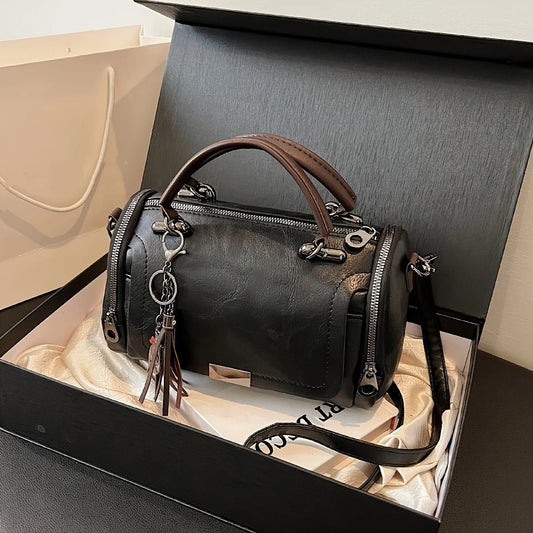 Vintage Tote Bag: Spacious multi-pocket design with tassel and metal accents, supports multiple carrying methods, combining practicality and style.black