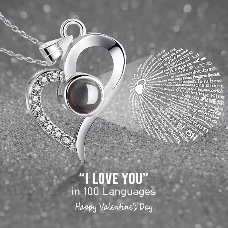 Platinum heart-shaped projection necklace, engraved with 100 ways to say "I love you," paired with matching heart-shaped earrings, presented in a rose-adorned double-door gift box—a refined gift blending technology and romance.