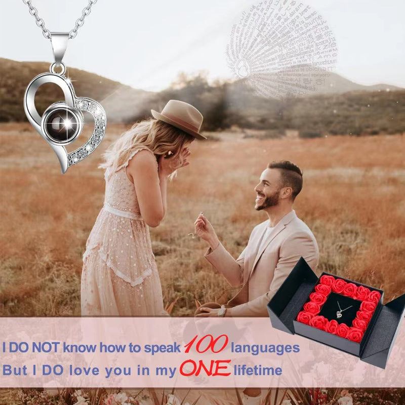 Platinum heart-shaped projection necklace, engraved with 100 ways to say "I love you," paired with matching heart-shaped earrings, presented in a rose-adorned double-door gift box—a refined gift blending technology and romance.