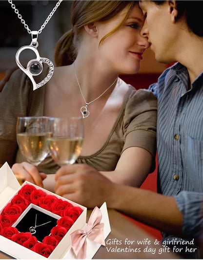 Platinum heart-shaped projection necklace, engraved with 100 ways to say "I love you," paired with matching heart-shaped earrings, presented in a rose-adorned double-door gift box—a refined gift blending technology and romance.