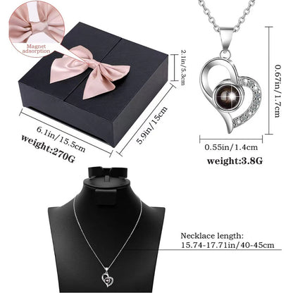 Platinum heart-shaped projection necklace, engraved with 100 ways to say "I love you," paired with matching heart-shaped earrings, presented in a rose-adorned double-door gift box—a refined gift blending technology and romance.