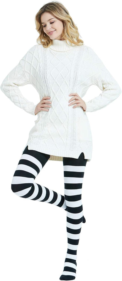 Woman wearing a white cable knit sweater and black and white striped leggings on a white background